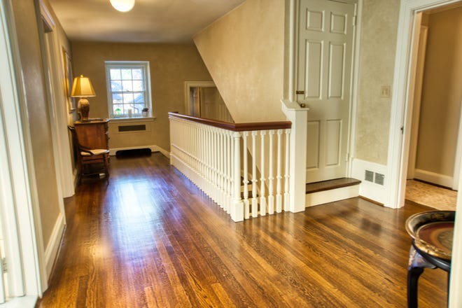 The landing upstairs features hardwood floors running between the master suite and hall bath at 2 Alapocas Drive.