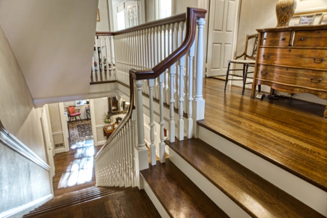 A grand staircase at 2 Alapocas Drive leads to the second floor.
