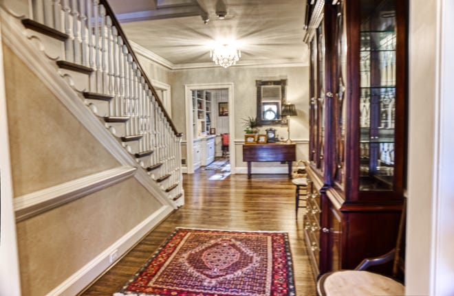 The spacious entry foyer at 2 Alapocas Drive opens to the den and other rooms.