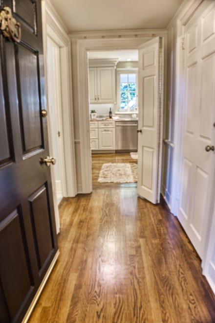 Hardwood floors line the hallways leading to the kitchen at 2 Alapocas Drive.