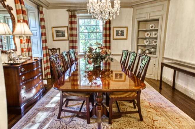 A formal dining room at 2 Alapocas Drive features millwork and a built-in china closet.