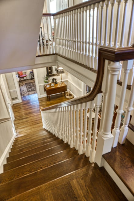 The room-size foyer at 2 Alapocas Drive opens to the living room and den, and features stairs to the second floor.