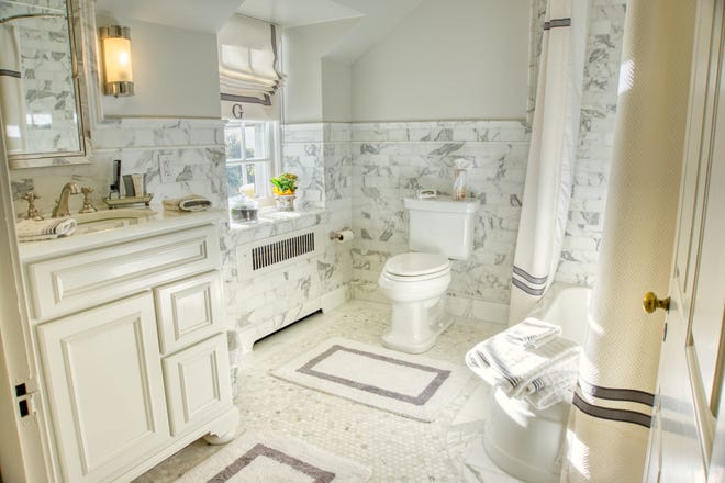 The hall bath at 2 Alapocas Drive features charm and a room to move around in.