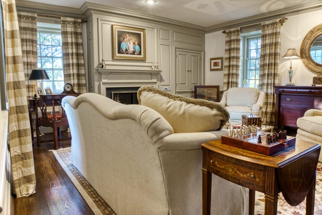 There's a fireplace and detailed moldings in the formal living room at 2 Alapocas Drive.