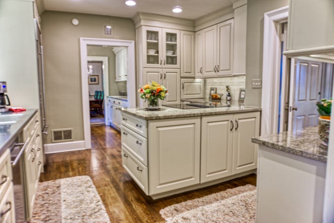 The kitchen at 2 Alapocas Drive features granite countertops and stainless steel appliances, and opens into the mudroom and butler's pantry.