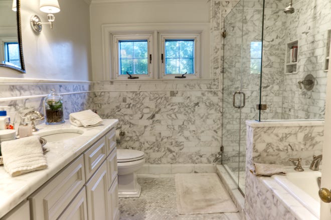 A luxurious master bath at 2 Alapocas Drive has double vanities, a tub and a shower.