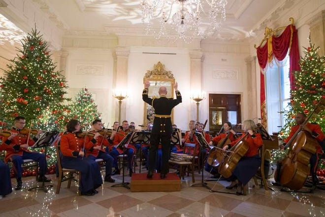 The 'President's Own' US Marine Band performs in the Grand Foyer during a viewing of the 2018 holiday decorations at the White House in Washington, D.C.