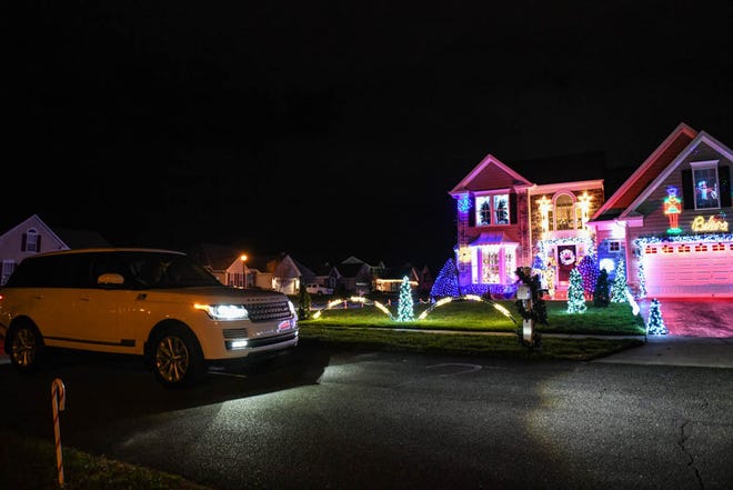 Cars stop to view 50,000 lights set to music illuminate a Lewes home for the holidays on Tuesday, Dec 4, 2018.