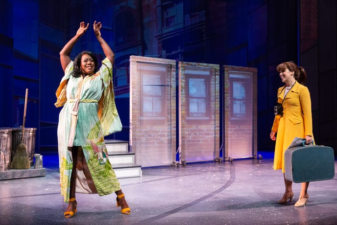 New roomie Tanya (Crystal Lucas Perry) welcomes Cindy (Chilina Kennedy) to New York in Delaware Theatre Co.'s 'A Sign of The Times.' The Three doors in the background are images projected on screens that constantly move and become part of many scenes.