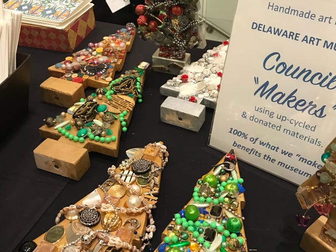Museum volunteers and others offer their own wares at the Museum's table, including these jeweled Christmas trees and folded paper ornaments.