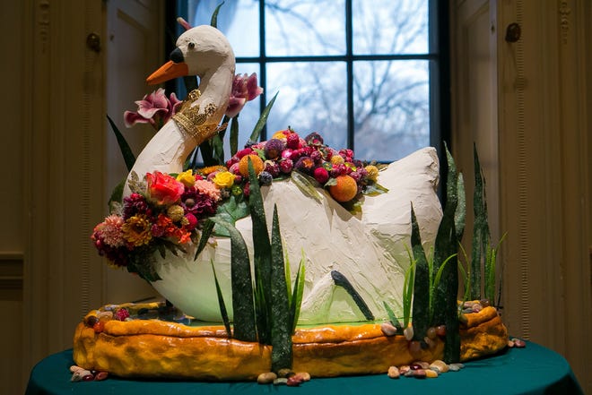 This recreation of a floral swan is a copy of a cake that's been remade in exhibit-safe materials.