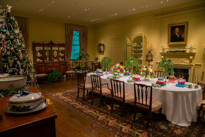 This years dining room display at Winterthur includes colorful presents stacked at each place.