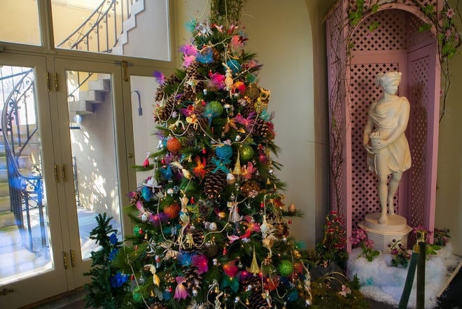A tree honoring Winterthur's children's garden and its current exhibit of garden follies is designed to look like fairies are the process of decorating the tree.