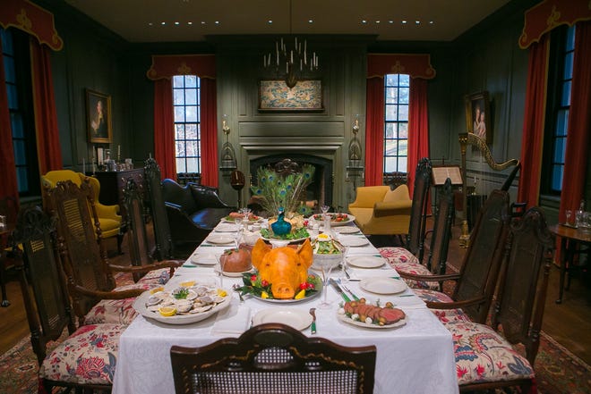 A sumptuous historical dinner is set in the Marlboro room at Winterthur, complete with a peacock centerpiece, during Yuletide at Winterthur. The museum has restricted some areas due to the coronavirus. Visitors must now wear masks.