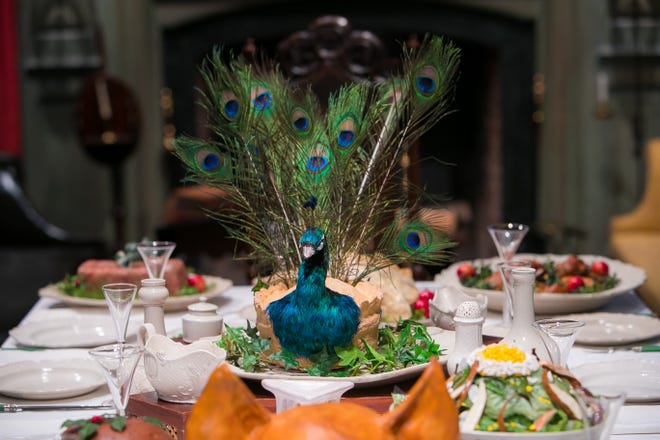 This table in Winterthur's Marlboro room is inspired by Washington Irving's tales of old English Christmases, complete with a hog's head and a centerpiece meat pie decorated like a peacock.