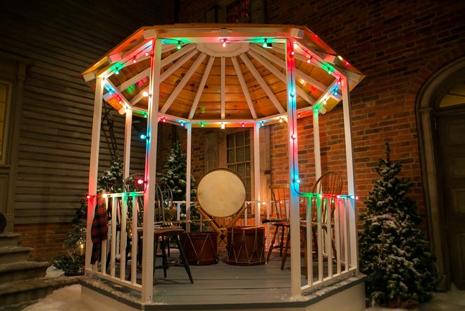 Guests can tour the Yuletide at Winterthur through Jan. 6. Here, a gazebo built to echo the estate's first outdoor exhibit of garden follies, welcomes guest in the court, which features the facades of four historic homes.
