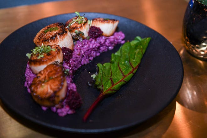 Seared day boat scallops and butterfly pea "purple" risotto at new Rehoboth Beach restaurant The Pines on Tuesday, Dec 11, 2018. The modern tavern aims to infuse classic dishes with creative, locally sourced ingredients.
