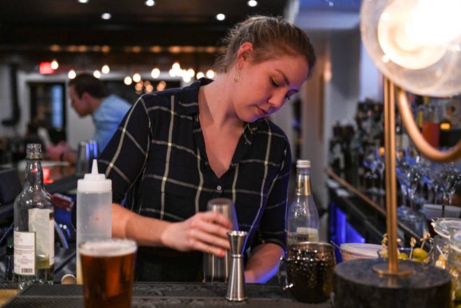 Rachel Martin, bartender and server at The Pines, makes drinks at the newly opened restaurant on Tuesday, Dec 11, 2018.