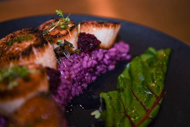 Seared day boat scallops and butterfly pea "purple" risotto at new Rehoboth Beach restaurant The Pines on Tuesday, Dec 11, 2018. The modern tavern aims to infuse classic dishes with creative, locally sourced ingredients.