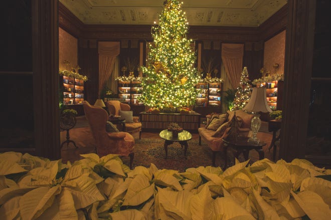 The dining room tree at A Longwood Christmas features a garland of books, as the 2018 show  takes on a theme of "trees reimagined."