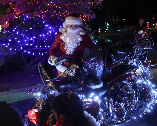 Delaware: Rocco Malin, the Motorcycle Santa, arrives at Ronald McDonald House in Rockland as he and a band of helpers delivers the product of their toy drive last week.
