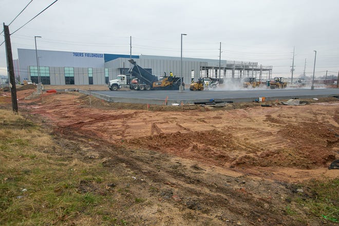 Paving of the parking lot area continues as construction delays have pushed the Delaware Blue CoatsÕ opening game in the new 76ers Fieldhouse to Jan. 23.