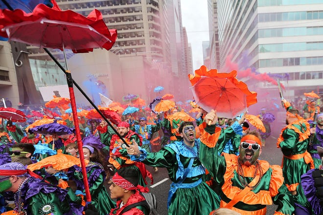 Members of the Saints Wench Brigade strut in front of the judges at City Hall during the Mummers Parade, Tuesday, Jan. 1, 2019, in Philadelphia. (David Maialetti/The Philadelphia Inquirer via AP)