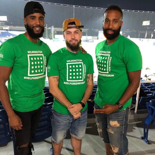 James L.A. Thompson (left) with fellow Wilmington Green Box co-founders John Naughton (center) and Jason Aviles at Frawley Stadium last year after their non-profit received a $15,000 donation from Capital One.