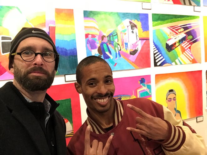 Michael Kalmbach, left, executive director of the Creative Vision Center, and transportation artist Geraldo Gonzalez celebrate the opening of his show on Market Street in Wilmington.