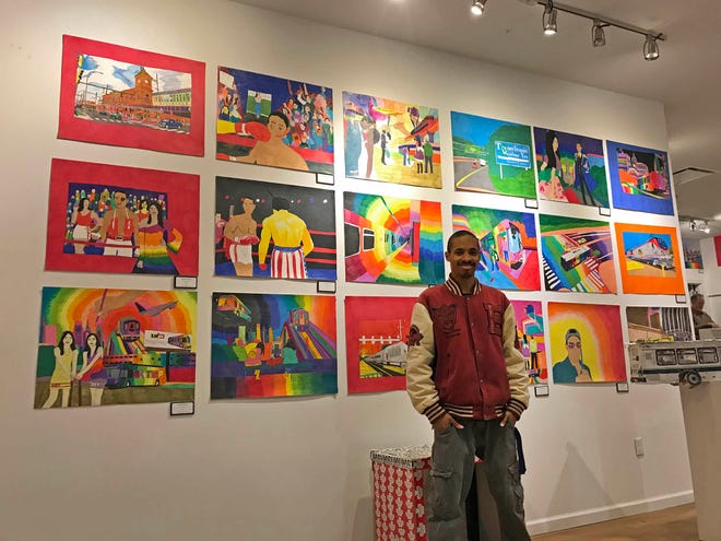 Geraldo Gonzalez, who often focuses on Wilmington's bus system, poses with a wider range of his work at an exhibit on Market Street.