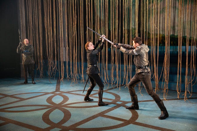 Charlie Del Marcelle, left, watches as Joan of Arc, center, played by Clare O'Malley, fights Sean Michael Bradley in  "St. Joan" at Delaware Theatre Company.