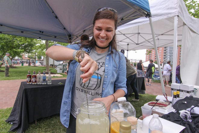 Katie Ramirez stirs a cocktail at the Painted Stave Distilling's tent during Bromberg's Big Noise in 2017.