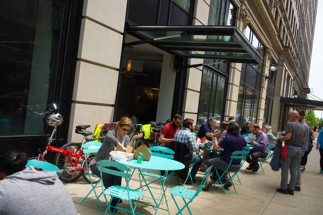 Patrons of the newly opened Wilmington food hall known as DECO  on the first floor of the Hotel duPont enjoy lunch in the outside dining area.