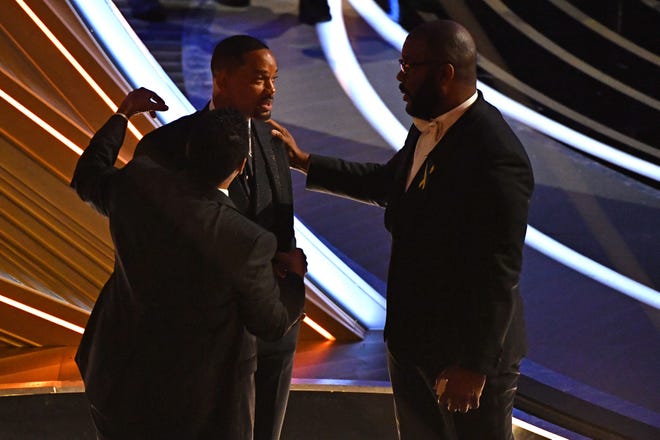 Denzel Washington, left, Will Smith, center, and actor-producer Tyler Perry chat during the 2022 Oscars in March following the slap heard around the world, in which Smith went onstage and slapped presenter and comedian Chris Rock for making a joke about his wife.