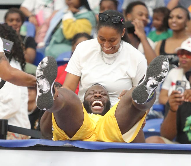 Body builder Robert Wilmote laughs as he nearly tumbles over a courtside table during the Duffy's Hope 19th Annual Celebrity Basketball Game at the Chase Fieldhouse in Wilmington, Saturday, August 5, 2023.