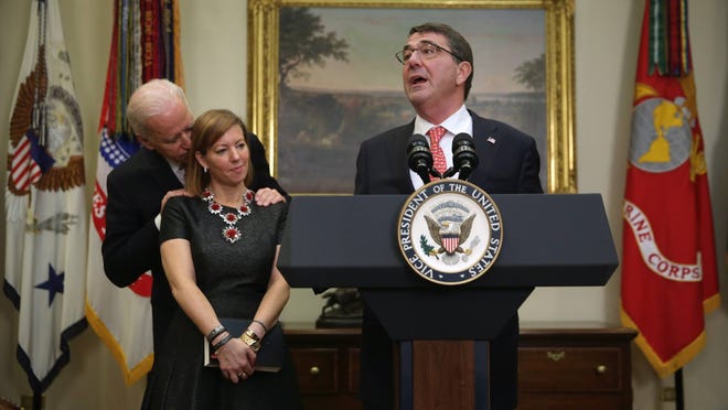 The photo that started it all: Vice President Joe Biden whispers to the wife of Ashton Carter after he was sworn in as U.S. Secretary of Defense Feb. 17 in the Roosevelt Room of the White House in Washington, D.C.