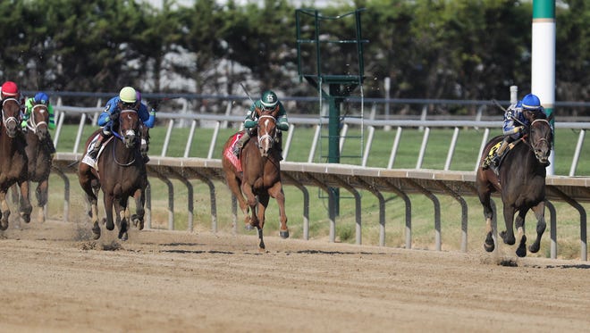 Elate (right), with jockey Jose Ortiz, gets some breathing room in the final strides to win the $750,000 Delaware Handicap Saturday at Delaware Park.