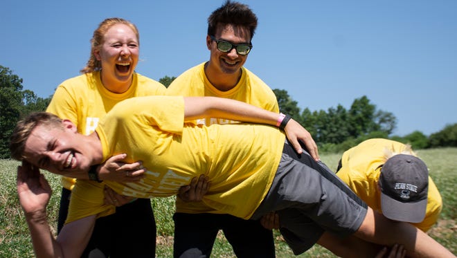 From left, Emily Marker, 19, Adam Zaidi 18, Sara Holden 17 try to lift Erik Rominiecki, 18 while they laugh in the process at The Great Inflatable Race in Shrewsbury, Pa. on Saturday, July 14, 2018. They are students at Penn State University in State College,Pa. and today they drove to have fun, they said.