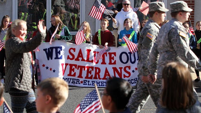 North Dover Elementary School students hold up a sign thanking veterans during the Toms River Veterans Day parade Monday, November 14, 2016.