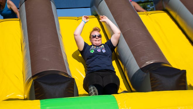 Bobbie Mellott from York goes down the slide at The Great Inflatable Race in Shrewsbury, Pa. on Saturday, July 14, 2018.