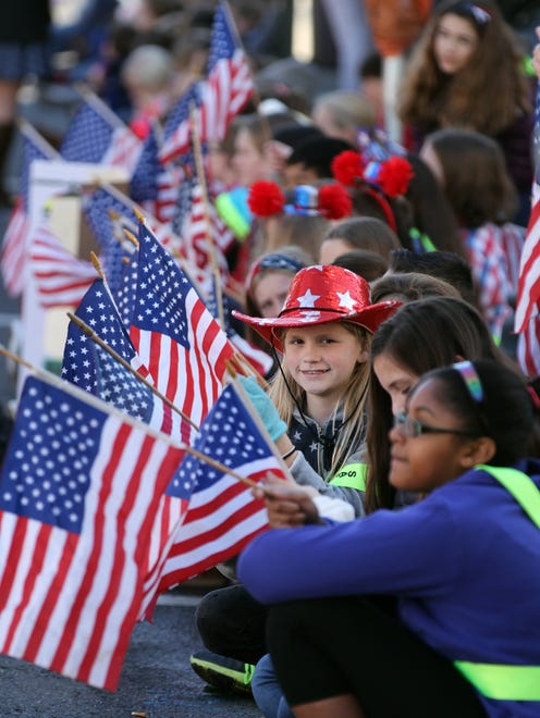 Silver Bay Elementary School 5th Grader Felicia Miller, 10, sports a patriotic hat along the parade route during the Toms River Veterans Day parade Monday, November 14, 2016.