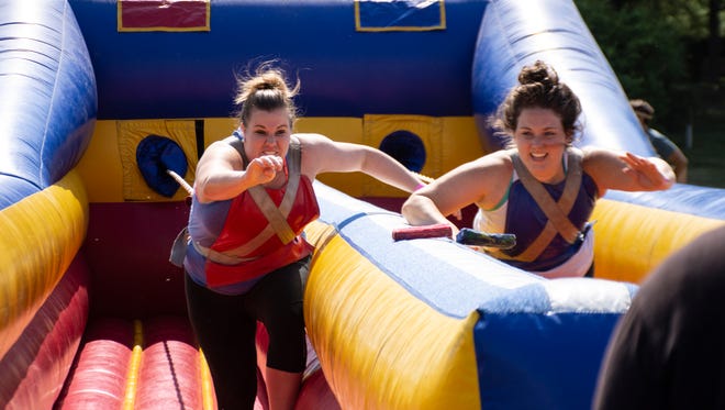 Danielle Korhonen and Courtney Irwin Pa. play a game at The Great Inflatable Race held in Shrewsbury,Pa. on Saturday, July 14, 2018.