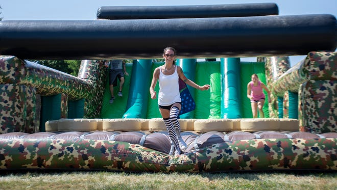 Kyle Delp runs through the obstacles course at The Great Inflatable Race in Shrewsbury, Pa. on Saturday, July 14, 2018.
