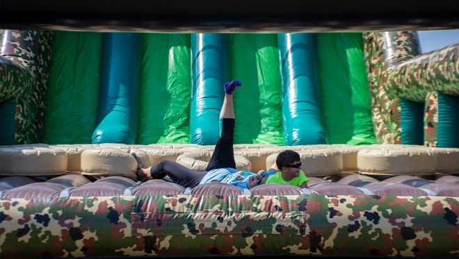 Karen Taylor and her grandson Dylan Taylor, fall and laugh together at The Great Inflatable Race in Shrewsbury, Pa. on Saturday, July 14, 2018.