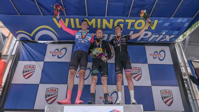 From left: Will Cooper of CS Belo Racing p/b Ca, Luke Mudgway of H&R Block Pro Cycling and Noah Granigan of CCB Foundation Sicleri celebrates on the winner circles after the twelfth Annual Wilmington Grand Prix Saturday, May. 19, 2018, on Market Street in Wilmington, Delaware.