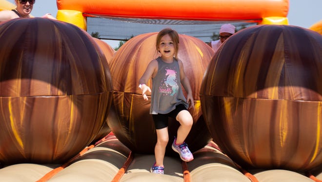 Isla Bromiley, 4, manage herself to go through the "food coma", a inflatable obstacle course, at The Great Inflatable Race in Shrewsbury, Pa. on Saturday, July 14, 2018.