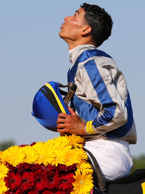 Jockey Jose Ortiz looks to the heavens after winning with Elate in the $750,000 Delaware Handicap Saturday at Delaware Park.