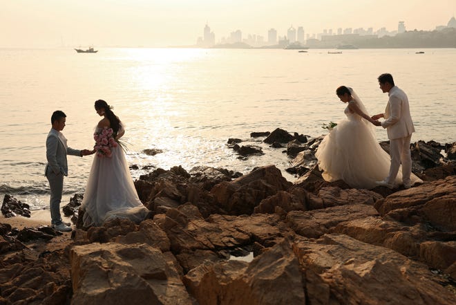 April 21, 2024 : Couples take part in their pre-wedding photoshoots by the sea in Qingdao, Shandong province, China.