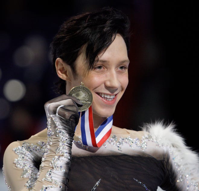 Johnny Weir shows off his medal for third place during the men's free skate at the U.S. Figure Skating Championships in Spokane, Wash., Sunday, Jan. 17, 2010.