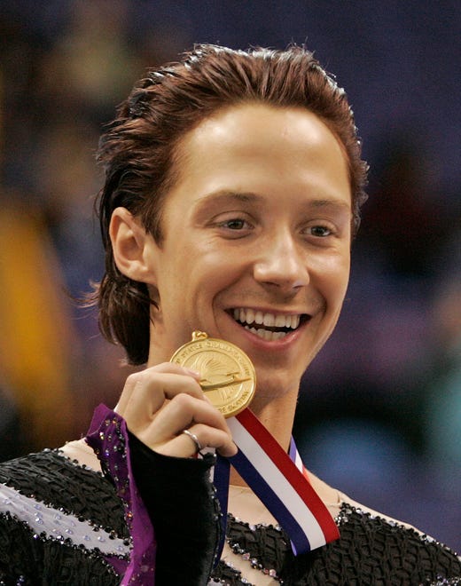 Johnny Weir shows off his gold medal after winning the men's free skate event at the U.S. Figure Skating Championships in St. Louis, Saturday, Jan. 14, 2006. Weir earned a spot on the U.S. Olympic team going to Turin.